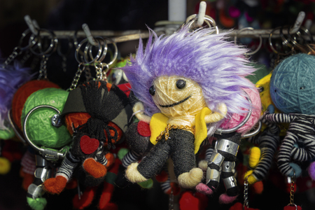 Homemade Doll-pendant from a skein of yarn in the shape of a little man in the gift shop on the street. Close-upの写真素材