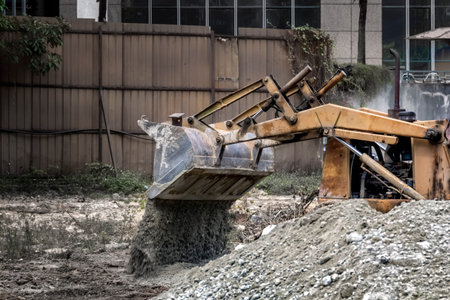bulldozer at the construction site pours rubble. Toned.