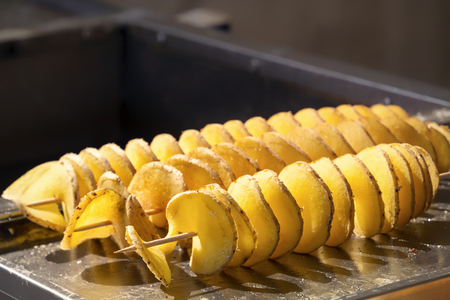 Fried potato chips on skewers. Close-up. Copy spaceの写真素材
