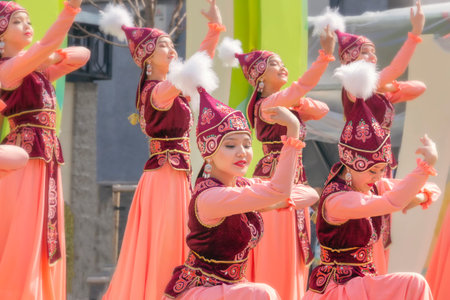 Almaty, Kazakhstan - March 23, 2019.Beautiful girls in national Kazakh costumes dance on the street...