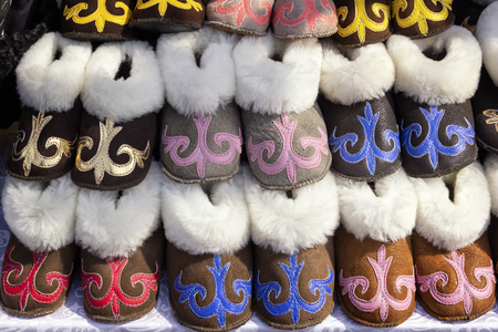 Traditional Asian shoes made of multicolored felt with embroidered colored thread of national ornament.の写真素材