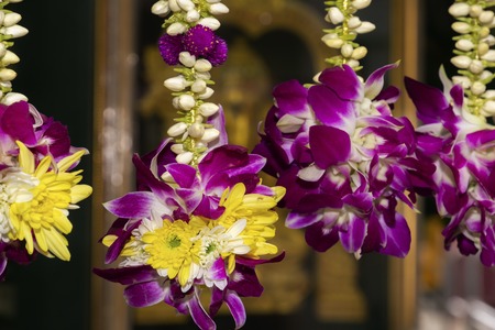 Traditional Buddhist ritual flower garlands are sold in street shops. Close-upの写真素材