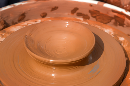 Preparation of a product from clay on a potter's wheel. Close-upの写真素材