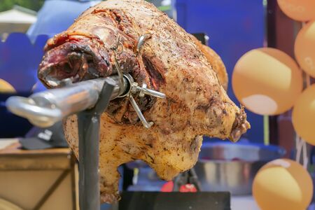 Lamb is roasted on a skewer over burning charcoal. Close-upの写真素材