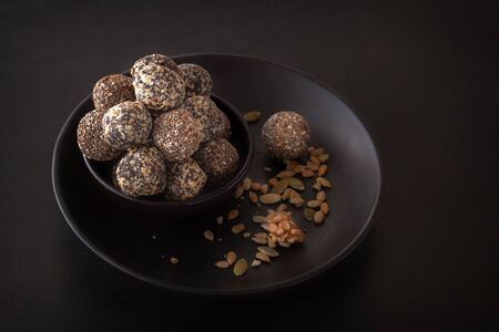 Healthy organic energy granola bites with nuts, cacao, banana and honey - sports food, vegetarian raw snackの写真素材