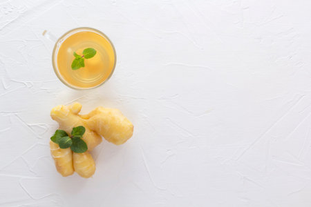 Tea with ginger and mint on a white wooden table. Copy space. Top viewの写真素材