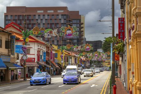 Singapore - January 8, 2020. Streets with old houses and shops on the background of modern buildings in the historic area of Little Indiaの写真素材