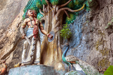 Kuala Lumpur, Malaysia - January 11, 2020. Sculpture of a deity split by an arrow into two halves in the complex of Batu cavesのeditorial素材