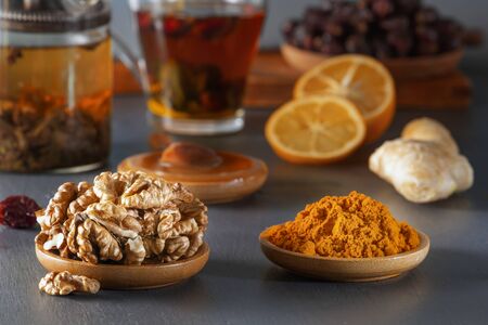 Ginger, walnut, turmeric, honey, lemon, dried rose hips and medicinal herbal tea - a means to increase immunity from the virus. Close-upの写真素材