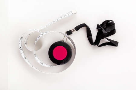 Tailor's tape measure on a white background. View from aboveの写真素材