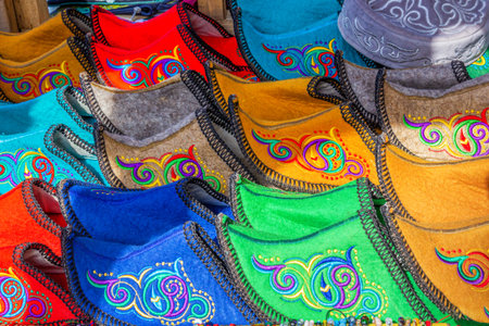 Traditional Asian shoes made of multicolored felt with embroidered colored thread of national...
