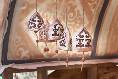 Clay bells with traditional Asian ornaments. close-up. Handmade