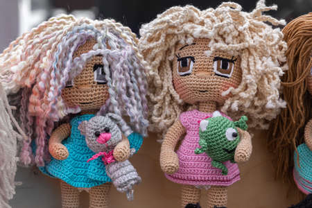 Colorful knitted handmade toys are on display for sale at a souvenir shopの写真素材