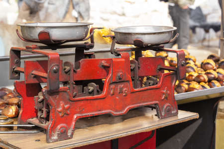 Antique scales for selling roasted chestnuts on the street. close-upの写真素材