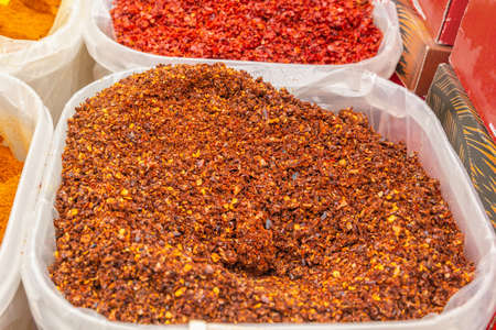 Ground red dry pepper is sold at a street bazaar. close-upの写真素材
