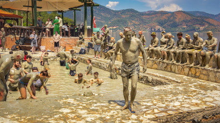 Dalyan, Turkey - May 9, 2022. People take mud baths in the pool of a natural spring on the shore of the lakeのeditorial素材