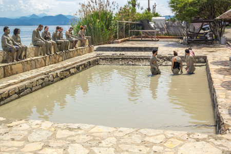 Dalyan, Turkey - May 9, 2022. People take mud baths in the pool of a natural spring on the shore of the lakeのeditorial素材