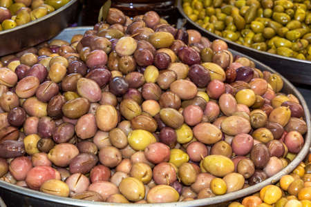 Multi-colored olives are sold at the street market. close-upの写真素材