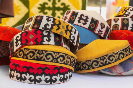 Traditional Asian headdresses from a multicolored felt with an embroidered colored thread of national ornament. close-upの写真素材