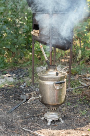 Wood-burning boiler for heating water with a smoking pipe - samovar outdoorsの写真素材