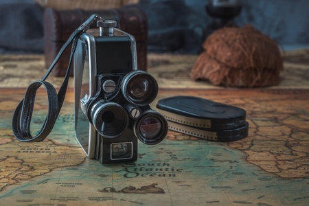 Vintage film camera with cassettes stands on an old nautical chart. Close-upの写真素材