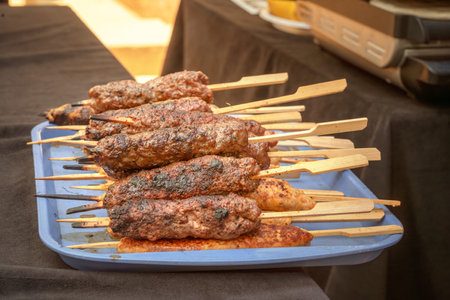 Meat kebabs on wooden skewers cooked on coals. Close-upの写真素材