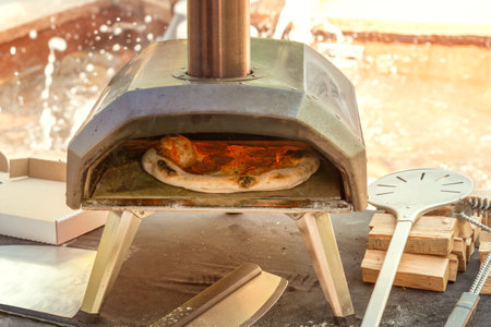 Pizza is cooked in a small wood-fired home oven.の写真素材