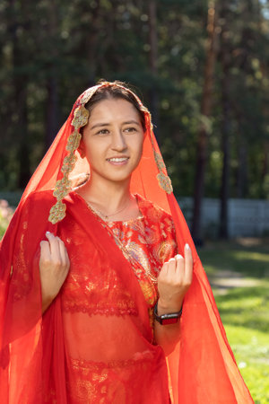 Burabay, Kazakhstan - August, 16, 2023. Young woman in Indian dance costume. Street portraitのeditorial素材