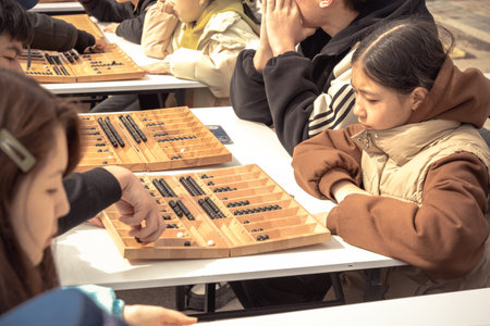Almaty, Kazakhstan - March 23, 2024. Children on the street play the Kazakh national board game Togyz kumalakのeditorial素材