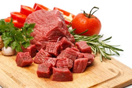 Raw fresh meat on board with condiments and vegetables close upの写真素材