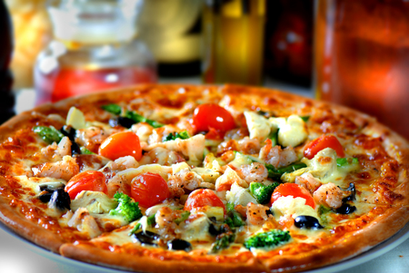 Fresh pizza with tomatoes, cheese and mushrooms on wooden table closeupの写真素材