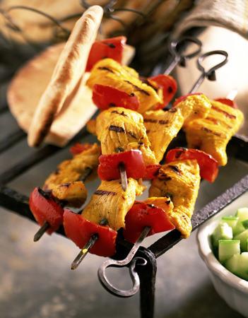 Grilled chicken fillet and tomatoes decorated on a tableの写真素材