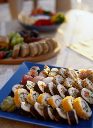 Salmon and philadelphia sushi rolls - asian food restaurant delivery, closeup of platter set on white backgroundの写真素材