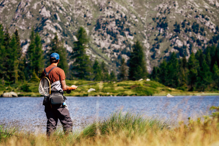 Spinning fishing (lure fishing) trout in lakes of the world. Brook trout (steelhead rainbow trout, char, bull-trout, cutthroat, lax, salmon and pink salmon caught on rotating spinner, close up photographyの写真素材
