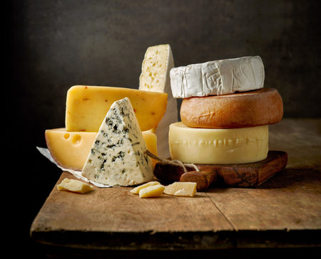 A close up of cheeseboard with different kinds of cheese for an appetizer