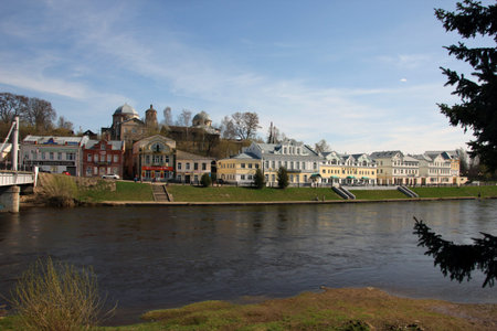 City view beautiful old building on the waterfront on the green bank of river Tvertsa, Torzhok,...