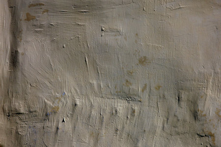 Roughly plastered and painted wall close up