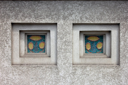niches with decorative inserts of ceramic tile on white plastered wall