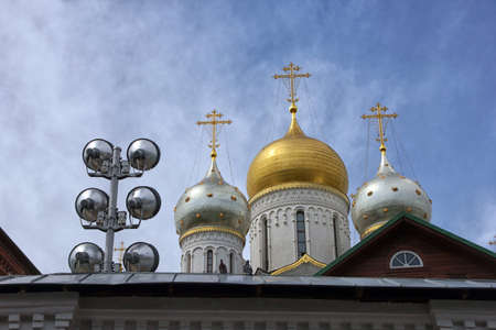 golden dome of russian orthodox cathedral and spotlight for lighting of buildings on roofの写真素材