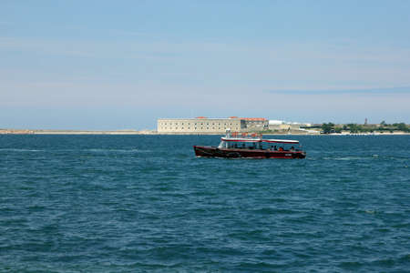 pleasure boat in blue sea on the background of crimean fortress in Sevastopol in Crimeaの写真素材