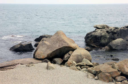 beautiful picturesque wild Black sea coast with boulders and rocks in sea waterの写真素材