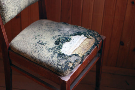 old wooden chair with a torn seatの写真素材