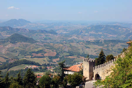 beautiful picturesque panoramic views of San Marino hills and old medieval stone castle wall with battlementsのeditorial素材