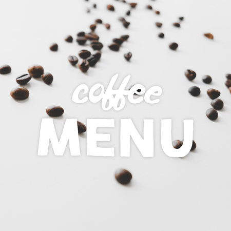 Coffee beans scattered on the table and hand drawn quote Coffee menu.の写真素材