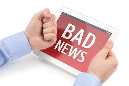 Mans hands threatening at the tablet computer screen on which displays the bad news message, isolated on a white background の写真素材
