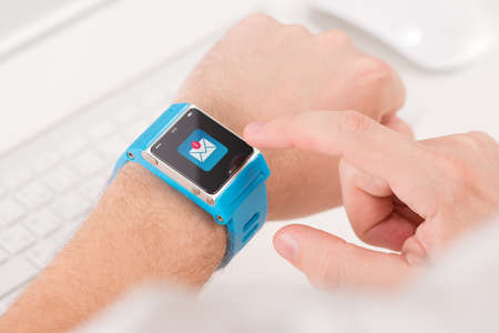 Male finger tap on the icon of unread messages on the smart watchの写真素材