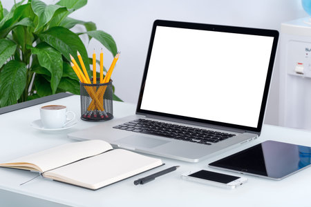 Laptop mockup with tablet computer, smartphone and notebook on the modern office desk. Consists of...