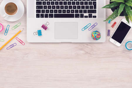 Office desk table workplace with laptop keyboard and smartphone top view flat lay with copy spaceの写真素材
