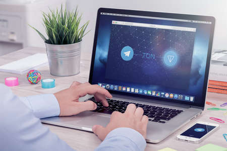 Varna, Bulgaria - January 23, 2018: Businessman reads Telegram Open Network TON white paper on ICO rating website. Telegram TON by Pavel Durov is the future of blockchain and cryptocurrency.のeditorial素材