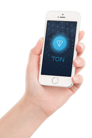 Varna, Bulgaria - January 23, 2018: Telegram Open Network TON logo white paper on iPhone display in female hand. Telegram TON by Pavel Durov is the future of blockchain and cryptocurrency.のeditorial素材